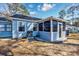Exterior of home with sunroom and yard with mature landscaping at 6839 Blue Heron Blvd. # 105, Myrtle Beach, SC 29588