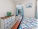 Comfortable bedroom with wood furnishings, patterned quilt, and natural light at 6839 Blue Heron Blvd. # 105, Myrtle Beach, SC 29588