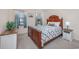 Comfortable bedroom with wood furnishings, patterned quilt, and natural light at 6839 Blue Heron Blvd. # 105, Myrtle Beach, SC 29588
