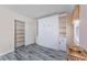 Bright bedroom features a murphy bed with custom cabinets, closet, and modern gray flooring at 6839 Blue Heron Blvd. # 105, Myrtle Beach, SC 29588