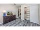 Comfortable bedroom with attractive wood-look flooring, dresser with TV, and a closet at 6839 Blue Heron Blvd. # 105, Myrtle Beach, SC 29588