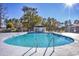Resort-style community pool with crystal clear water surrounded by mature trees at 6839 Blue Heron Blvd. # 105, Myrtle Beach, SC 29588