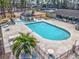 Inviting community pool area featuring a hot tub, picnic tables, and lush landscaping at 6839 Blue Heron Blvd. # 105, Myrtle Beach, SC 29588
