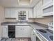 Bright kitchen features white cabinets, modern appliances, and a sunlit window at 6839 Blue Heron Blvd. # 105, Myrtle Beach, SC 29588