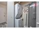 Convenient laundry room featuring a stacked washer and dryer at 6839 Blue Heron Blvd. # 105, Myrtle Beach, SC 29588
