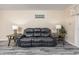 Living room featuring a black leather sofa flanked by two end tables with lamps at 6839 Blue Heron Blvd. # 105, Myrtle Beach, SC 29588