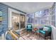 Relaxing enclosed porch with light blue decor and comfortable seating arrangements at 6839 Blue Heron Blvd. # 105, Myrtle Beach, SC 29588