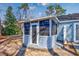 Backyard sunroom, featuring screened windows, access door, and concrete base at 6839 Blue Heron Blvd. # 105, Myrtle Beach, SC 29588