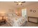 A serene bedroom bathed in soft light featuring a floral bedspread and tasteful decor at 724 Alexis Dr., Longs, SC 29568