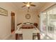 Bright dining room showcasing a modern table, decorative lighting, and access to outdoor patio at 724 Alexis Dr., Longs, SC 29568