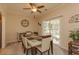 Dining area features a modern table, ceiling fan, and sliding glass doors to the patio at 724 Alexis Dr., Longs, SC 29568