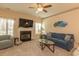 Relax in the spacious living room, featuring a cozy fireplace, large TV, and comfortable blue sofa with decorative pillows at 724 Alexis Dr., Longs, SC 29568