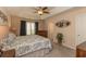 Spacious main bedroom featuring a tray ceiling, ceiling fan, and lots of natural light at 724 Alexis Dr., Longs, SC 29568