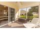 Cozy screened porch with outdoor furniture, ceiling fan, and peaceful backyard view at 724 Alexis Dr., Longs, SC 29568