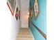 Bright stairway with carpet runner, white walls, blue accent wall and art at 829 9Th Ave. S, North Myrtle Beach, SC 29582