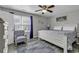 Comfortable bedroom with a ceiling fan, a striped chair, and lots of natural light at 912 Tiffany Ln., North Myrtle Beach, SC 29582