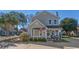 Charming two-story home with blue siding, bay window, landscaped yard, and American flag at 912 Tiffany Ln., North Myrtle Beach, SC 29582