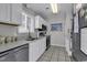 Well-lit kitchen with granite countertops, stainless steel appliances, and tile flooring at 912 Tiffany Ln., North Myrtle Beach, SC 29582