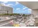 Balcony view overlooking a parking area with views of the beach and a high-rise condominium in the distance at 9820 Queensway Blvd. # 301, Myrtle Beach, SC 29572