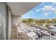 Balcony seating area with views of a lush tree line, parking area, and condo buildings at 9820 Queensway Blvd. # 301, Myrtle Beach, SC 29572
