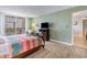 Cozy bedroom featuring comfortable bed, wood floors, and balcony access with great natural light at 9820 Queensway Blvd. # 301, Myrtle Beach, SC 29572