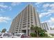 Large high-rise condo building featuring private balconies with parking and landscaped ground at 9820 Queensway Blvd. # 301, Myrtle Beach, SC 29572