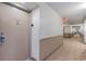 Hallway leading to unit with neutral carpet and paint with an exit sign at 9820 Queensway Blvd. # 301, Myrtle Beach, SC 29572