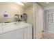 Practical laundry area with a washer, dryer, and built-in shelving for storage at 9820 Queensway Blvd. # 301, Myrtle Beach, SC 29572