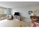Living area featuring a large window overlooking the balcony and a comfortable sitting area at 9820 Queensway Blvd. # 301, Myrtle Beach, SC 29572
