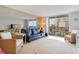 Spacious living room features balcony access with beautiful outdoor views at 9820 Queensway Blvd. # 301, Myrtle Beach, SC 29572