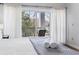 Balcony view with seating off a comfortable bedroom with white curtains at 1017 World Tour Blvd. # 206, Myrtle Beach, SC 29579