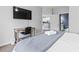Cozy bedroom featuring a desk and chair, and a view of a brightly-lit bathroom and kitchen at 1017 World Tour Blvd. # 206, Myrtle Beach, SC 29579