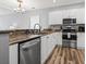 Bright kitchen featuring stainless steel appliances, ample counter space and laminate floors at 1017 World Tour Blvd. # 206, Myrtle Beach, SC 29579