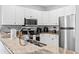 Well-lit kitchen features granite countertops, stainless steel appliances, and white cabinets at 1017 World Tour Blvd. # 206, Myrtle Beach, SC 29579