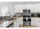 Bright kitchen with stainless steel appliances, granite countertops, and modern white cabinets at 1017 World Tour Blvd. # 206, Myrtle Beach, SC 29579