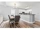 Kitchen and dining area featuring white cabinetry and stainless steel appliances and laminate floors at 1017 World Tour Blvd. # 206, Myrtle Beach, SC 29579