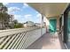 Balcony showing neighborhood views with white railing and a small seating area at 105 S Ocean Blvd. # 108, North Myrtle Beach, SC 29582