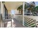 Outdoor seating on covered balcony with white railing overlooking community at 105 S Ocean Blvd. # 108, North Myrtle Beach, SC 29582