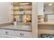 Bar area with open shelving and a sink, flowing into the living room and kitchen at 105 S Ocean Blvd. # 108, North Myrtle Beach, SC 29582