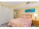 Bright bedroom featuring coastal decor with tropical-themed bedding and an accent fish painting at 105 S Ocean Blvd. # 108, North Myrtle Beach, SC 29582