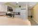 Well-lit kitchen featuring white cabinetry, stainless steel appliances, and laminate countertops at 105 S Ocean Blvd. # 108, North Myrtle Beach, SC 29582