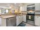 Bright kitchen featuring stainless steel appliances, white cabinets and stylish gray flooring at 105 S Ocean Blvd. # 108, North Myrtle Beach, SC 29582