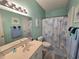 Well-lit bathroom featuring a vanity with double sinks and a shower with jellyfish-themed curtain at 1058 Sea Mountain Hwy. # 14-203, North Myrtle Beach, SC 29582