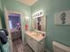 Bright bathroom featuring a white vanity, beachy decor, and access to the bedroom at 1058 Sea Mountain Hwy. # 14-203, North Myrtle Beach, SC 29582