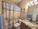 Nautical bathroom with a decorative shower curtain, granite counter, and a decorative mirror at 1058 Sea Mountain Hwy. # 14-203, North Myrtle Beach, SC 29582