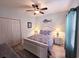Comfortable bedroom with a decorative headboard, ceiling fan, and ample closet space at 1058 Sea Mountain Hwy. # 14-203, North Myrtle Beach, SC 29582
