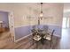 Inviting dining area with a glass table, decorative lighting, and calming wall colors at 1058 Sea Mountain Hwy. # 14-203, North Myrtle Beach, SC 29582