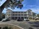 Three story condo building showing exterior walkways, brick facade, and ample parking at 1058 Sea Mountain Hwy. # 14-203, North Myrtle Beach, SC 29582