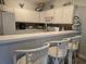 Well-lit kitchen with white cabinets, breakfast bar, and unique coastal decorative touches at 1058 Sea Mountain Hwy. # 14-203, North Myrtle Beach, SC 29582