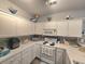 Well-lit kitchen with white cabinets, peninsula, and unique coastal decorative touches at 1058 Sea Mountain Hwy. # 14-203, North Myrtle Beach, SC 29582